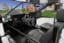 Close up of two seat driving cab with four screens showing a suburban environment